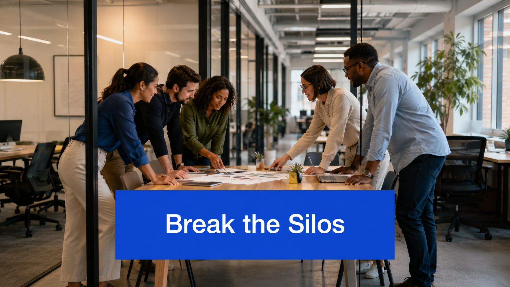 A diverse team of professionals collaborate around a table in a modern office space discussing business strategies.